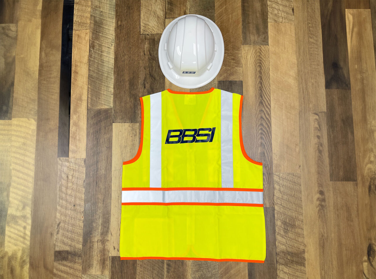Example of Morel's apparel capabilities, showing a branded reflective vest and hard hat for their client, BBSI.