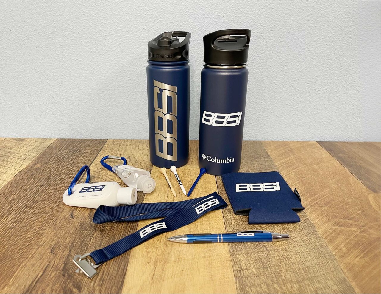 Example of Morel's promotional capabilities, showing branded water bottles, hand sanitizers, lanyard, and pen.