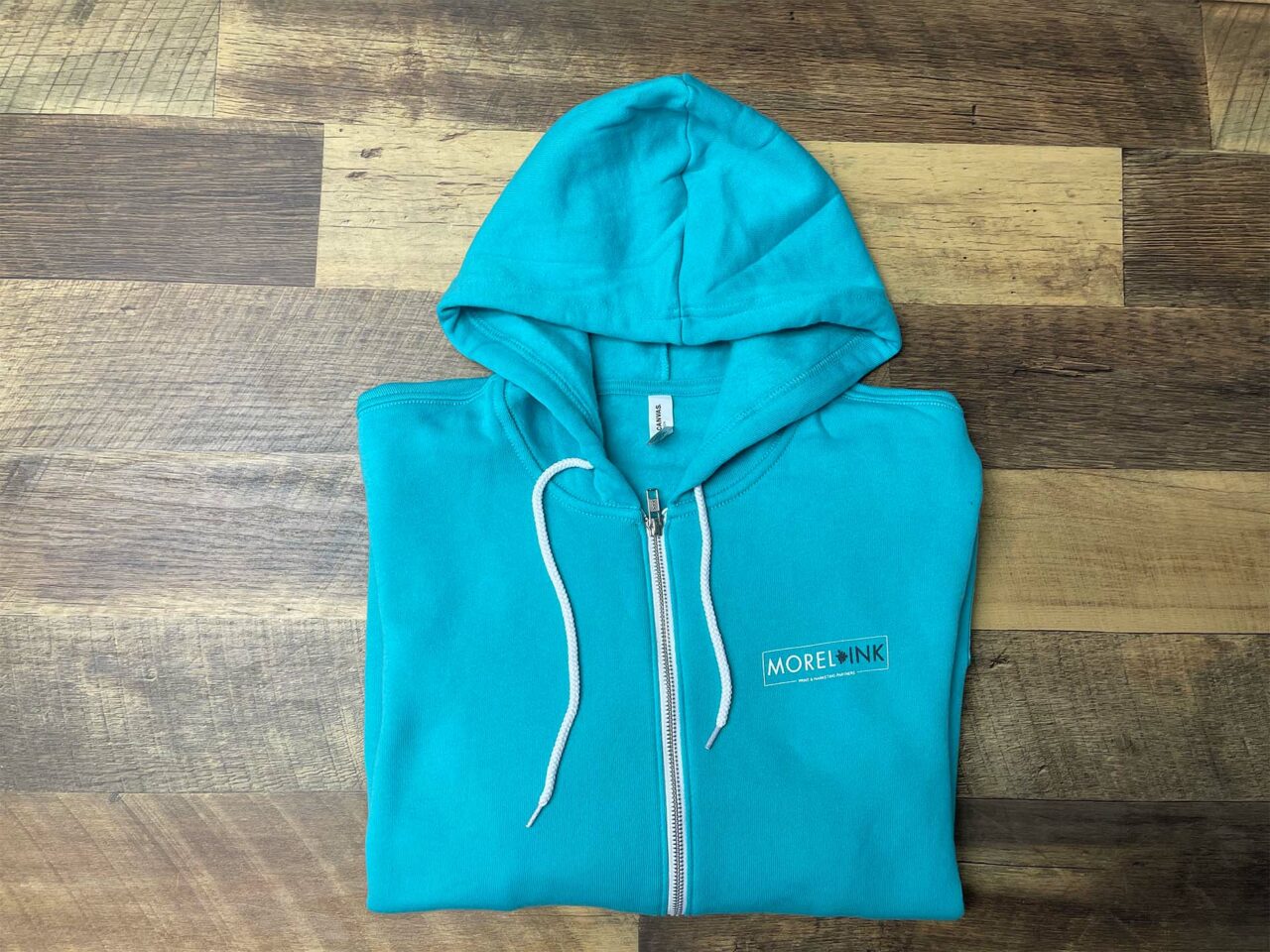 Example of Morel's apparel capabilities, showing a custom branded zip-up hoodie