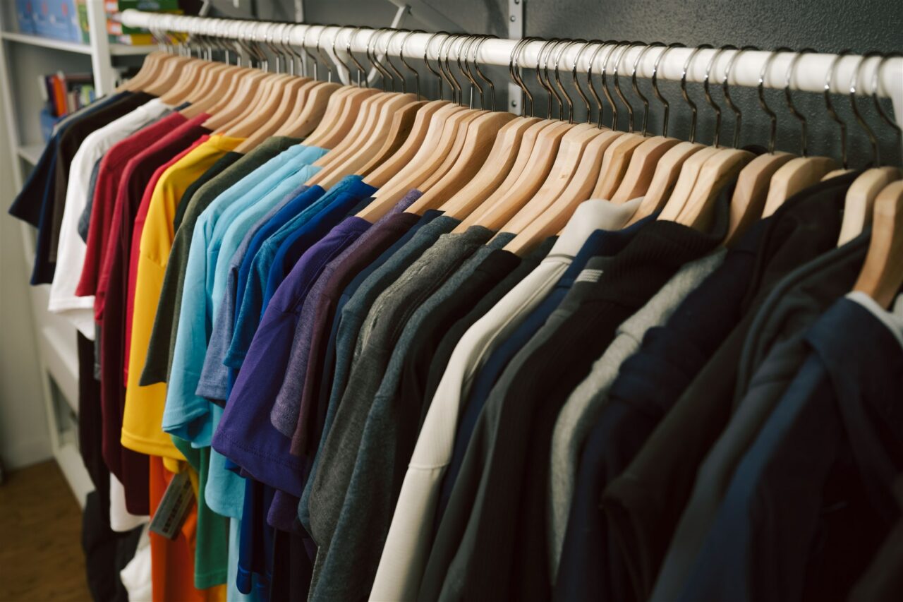 Morel's apparel capabilities across a rack full of colorful custom branded t-shirts