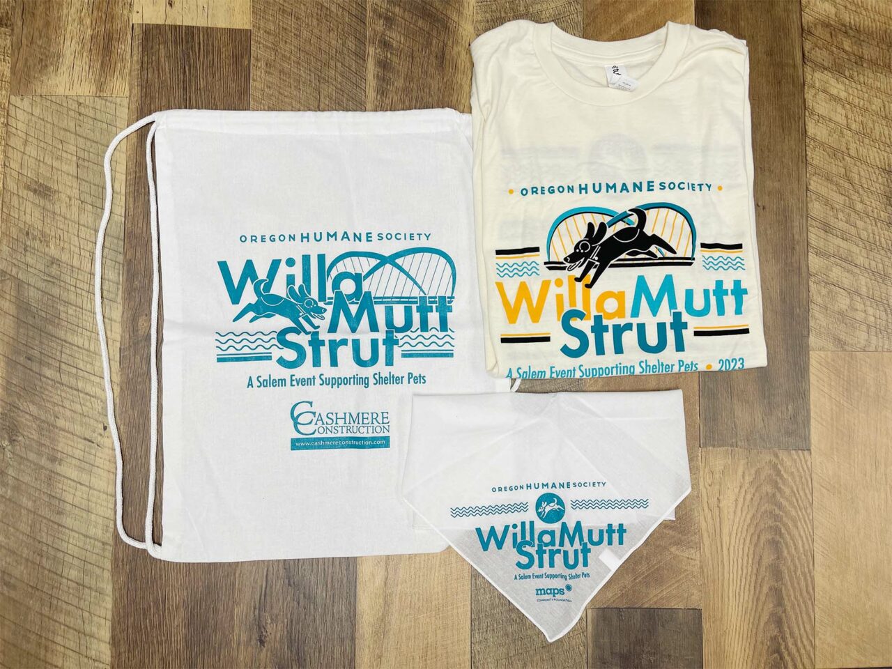 Example of Morel's promotional and apparel capabilities, showing a branded t-shirt, bandana, and backpack for the WillaMutt Strut