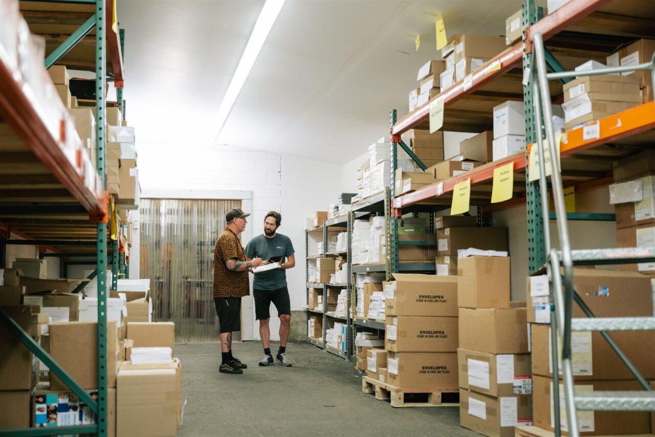 Two Morel Ink team members showcase their warehousing and inventory capabilities