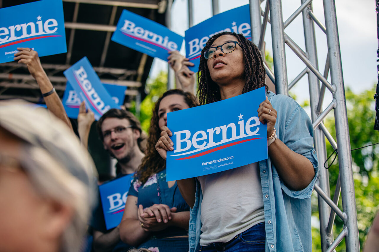 An example of Morel's political printing capabilities, showing someone at a rally holding a custom sign for the Bernie Sanders campaign